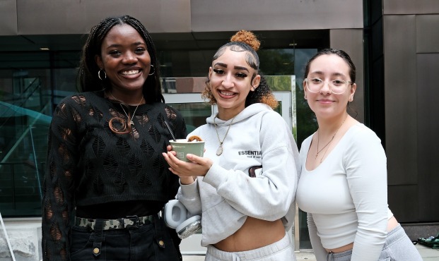 Smiling female students in front of Hammond Hall. 