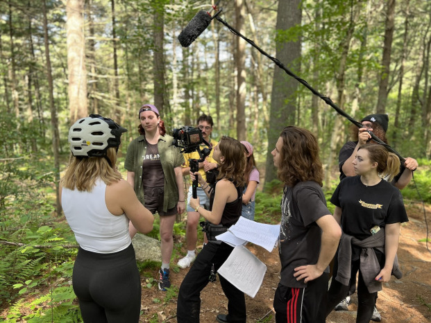 Balls of Tin students and actors filming in woods.