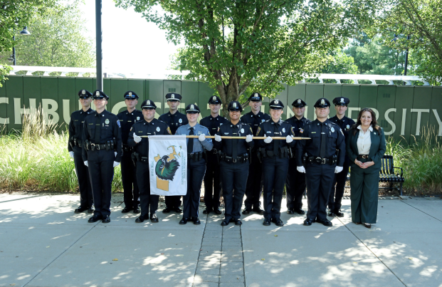 President Hodge poses with police recruits at ROC ceremony