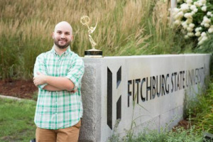 Comm media student with his Emmy