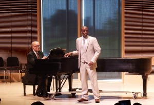 Jacsonn Jean on stage in front of the piano 