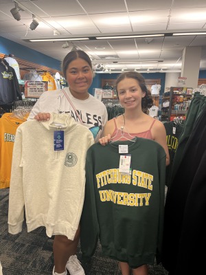 Female students in bookstore with sweatshirts