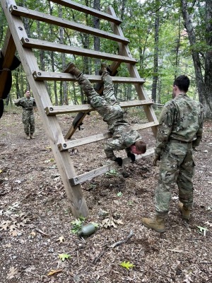 ROTC recruits on ladder in woods
