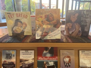 Closeup of Library Native American Heritage Book Display featuring the following children's picture books:  Fry Bread, Hiawatha and the Peacemaker, and I Sang You Down from the Stars