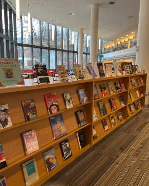 Book display on wooden shelves with various books for National Arab American Heritage Month
