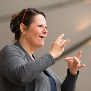 An interpreter translating spoken words into sign language.