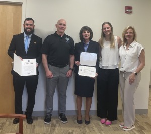 Julia Gauvin and Renee Scapparone receive the Patriotic Award during a ceremony at Fitchburg State University. 