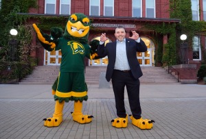 Alum Jason Polonsky goes Talons Up with mascot Freddy in front of Thompson Hall
