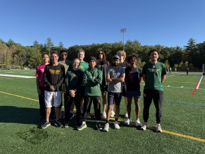 Men's cross country team with Burns and Guevara Mateo at Elliot Field