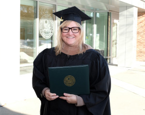 Teacher of the Year Linda Alvarez receives her diploma on campus