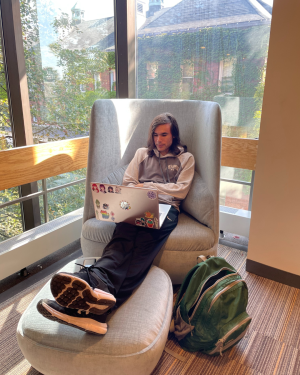 Student sitting in the library with new furniture