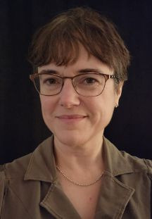 Laura Robinson Dean of Library, a white middle age woman with short brown hair and glasses