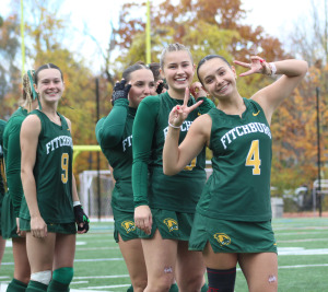 She Soars women's field hockey team smiles