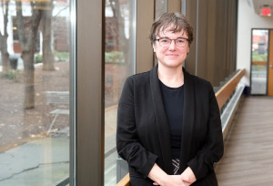 Dean of Library Laura Robinson standing next to library windows