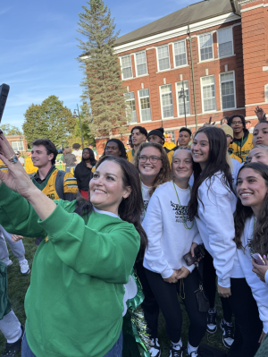 President Hodge poses for selfie with students at pep rally