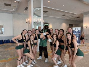 Fitchburg State cheer squad standing with a mascot