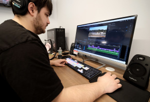  Aiden Truehart working at computer on Civic Center documentary.