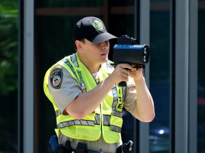 Collin Dudek checks car speeds with a radar gun