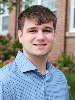 Justin Conner from Admissions headshot outside.