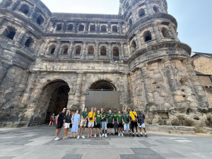 Men's basketball team standing in front of 2000-year old Roman Fortress in Trier. 