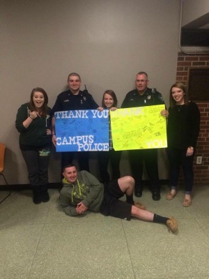Students and officers holding posters reading, "Thank you Campus Police!"