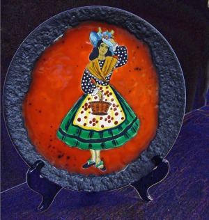 A 'fat lava' pottery plate with a woman painted on it