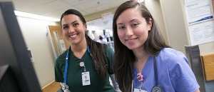 Julia Zamanian and Claribell Gomez in their nursing uniforms