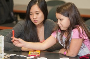 College student teaching a young girl